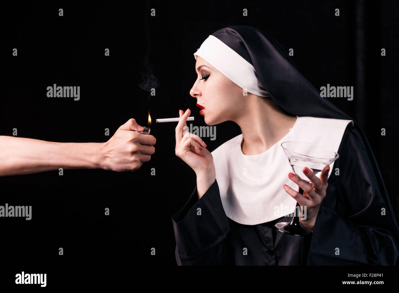 Smoking young nun Stock Photo. 