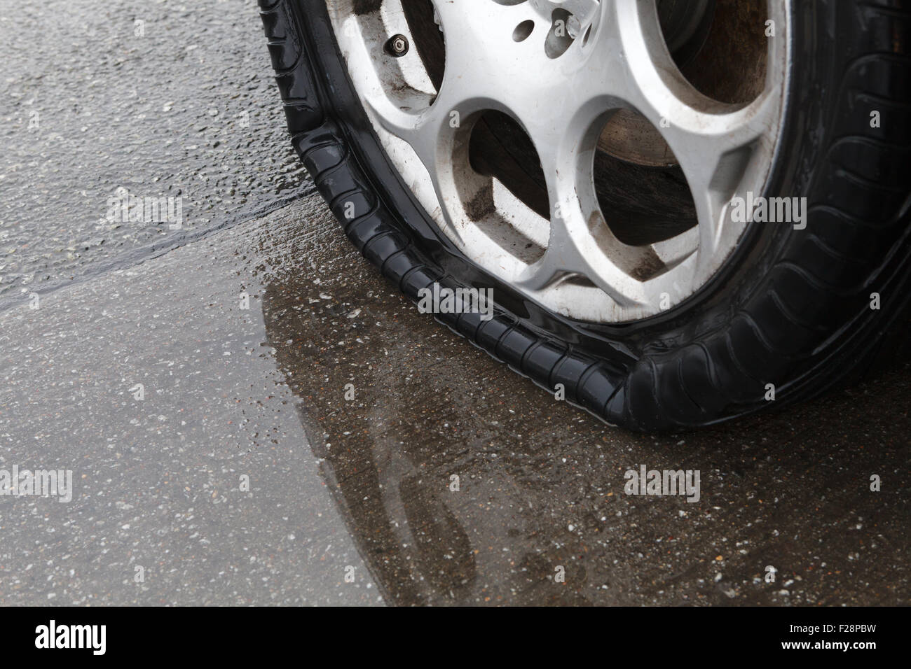Flat tire on wet road Stock Photo Alamy
