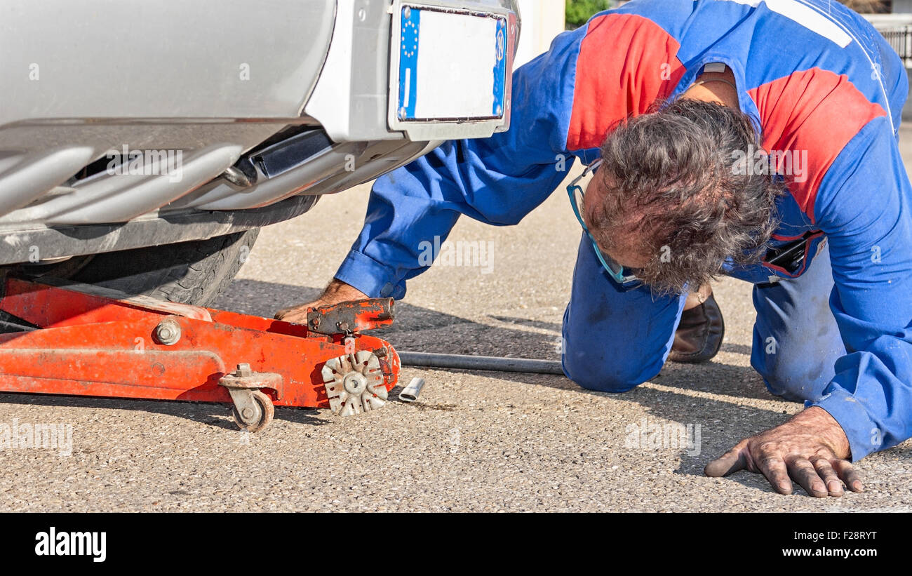 mechanician work under a car Stock Photo Alamy