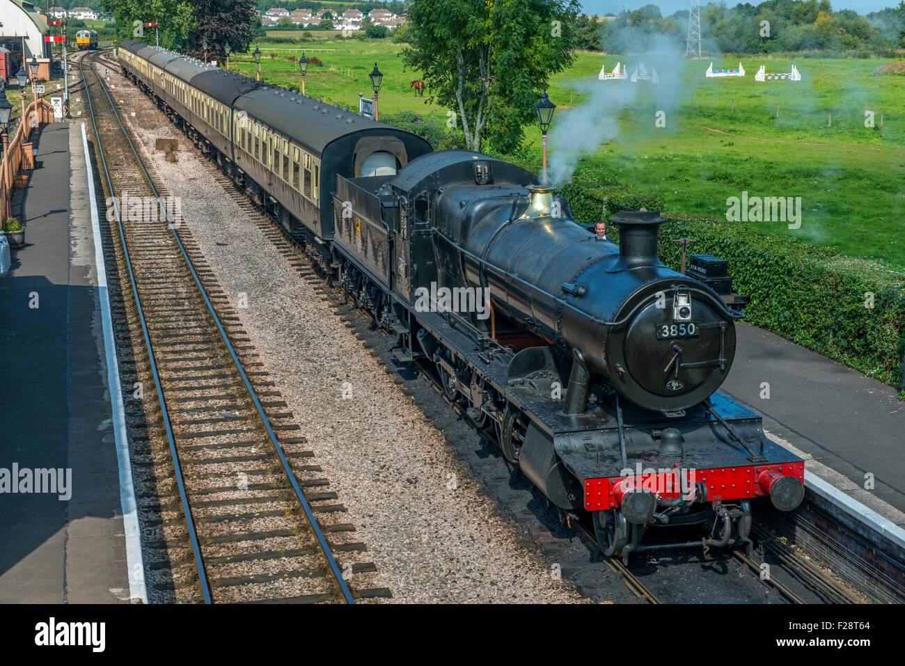Steam Engine coming into Williton Station from Minehead on the West Somerset Railway on a sunny September afternoon Stock Photo