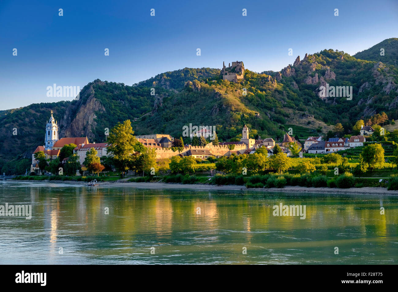 Durnstein on the banks of the Danube in Austria in the Wachau Valley.Ruins of   Kuenringer Castle on the hilltop . Church spire. Stock Photo