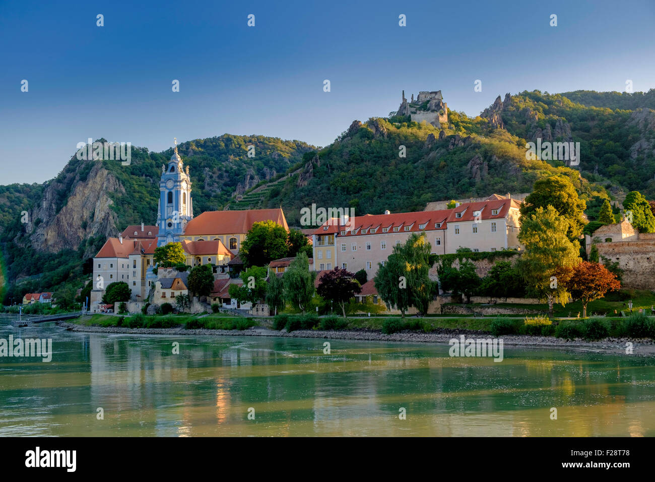Durnstein on the banks of the Danube in Austria in the Wachau Valley.Ruins of   Kuenringer Castle on the hilltop . Church spire. Stock Photo