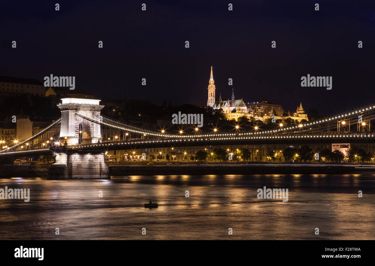 A beautiful night-time view of the Chain Bridge spanning the River Danube with the Fisherman’s Bastion and St. Matthias Church i Stock Photo