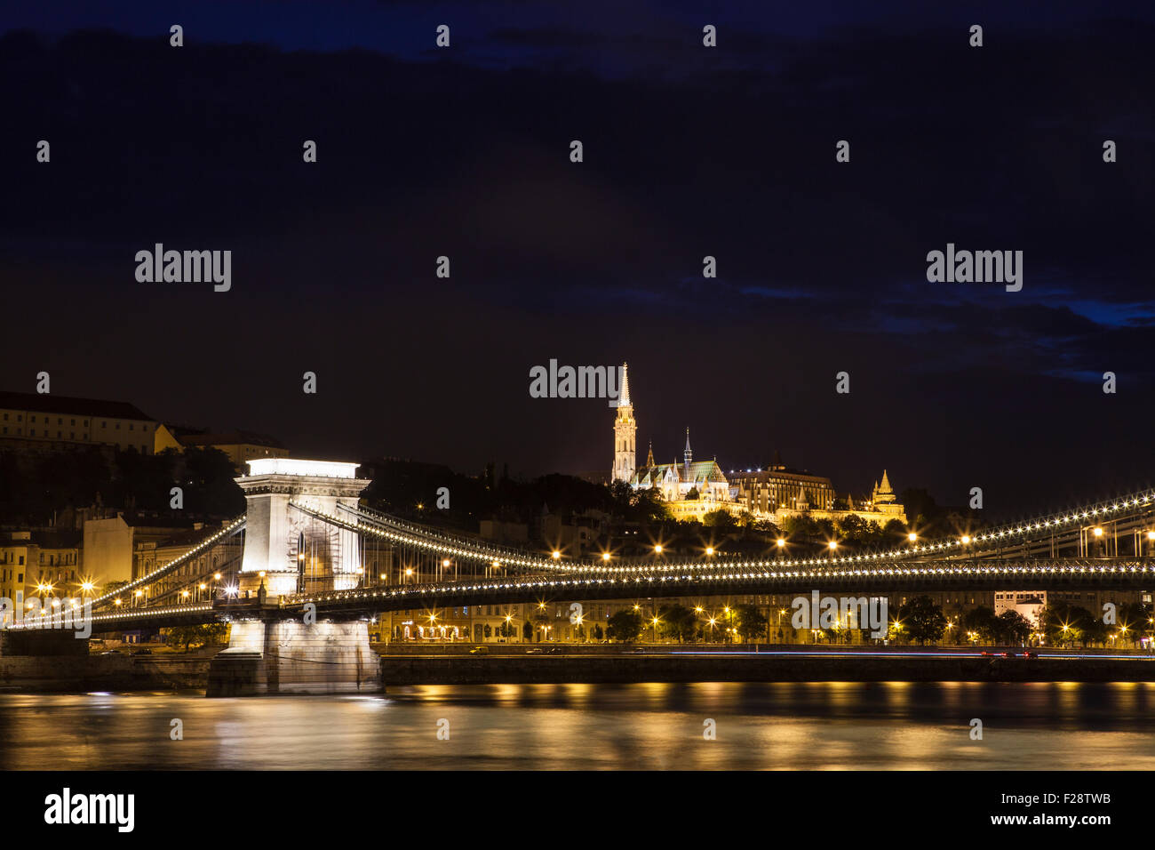 A beautiful night-time view of the Chain Bridge spanning the River Danube with the Fisherman’s Bastion and St. Matthias Church i Stock Photo