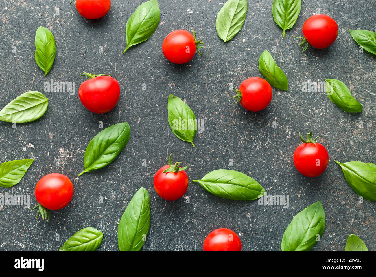 tomatoes and basil leaves on kitchen table Stock Photo - Alamy