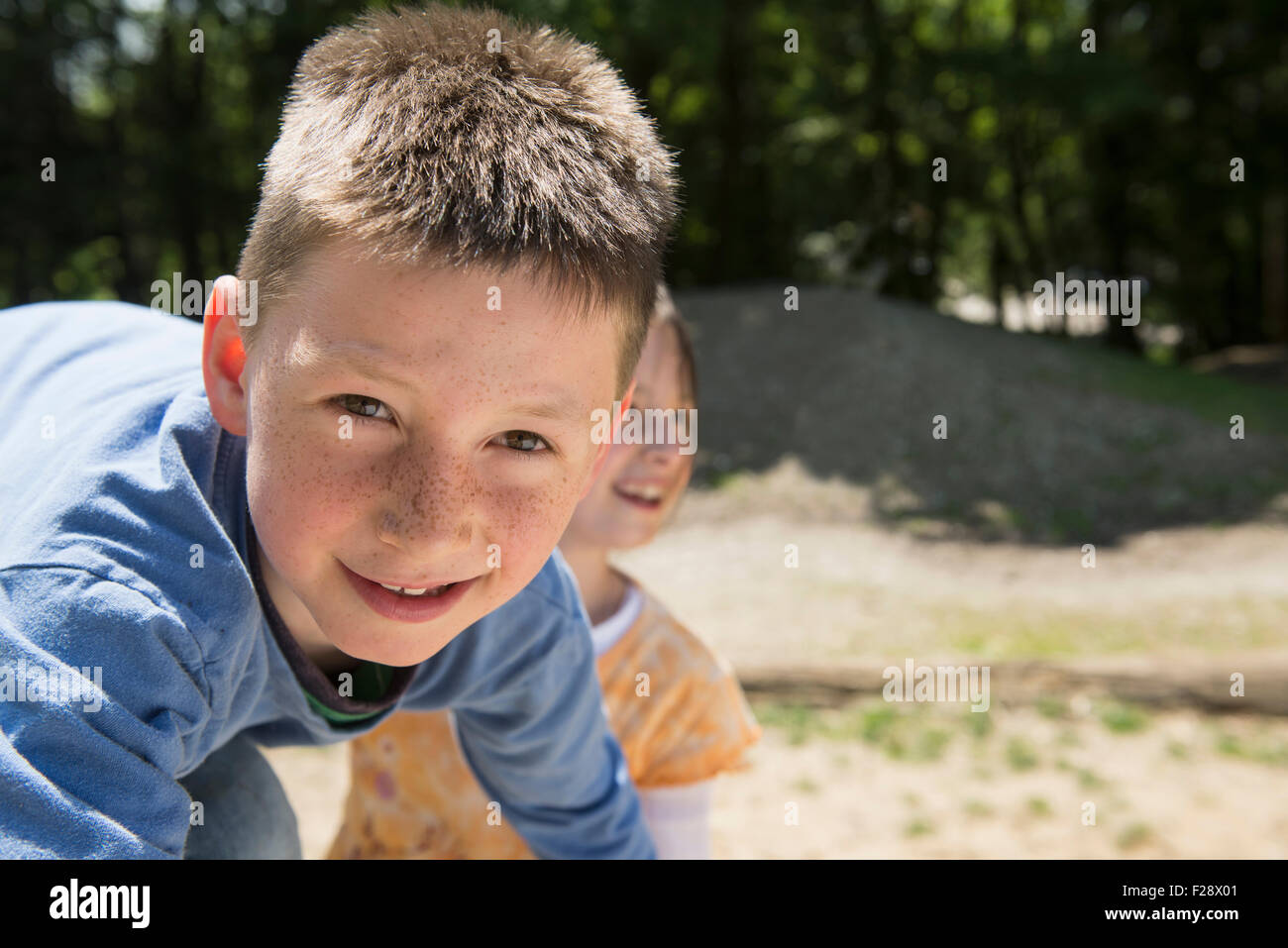 Boy and girl playing in playground, Munich, Bavaria, Germany Stock Photo