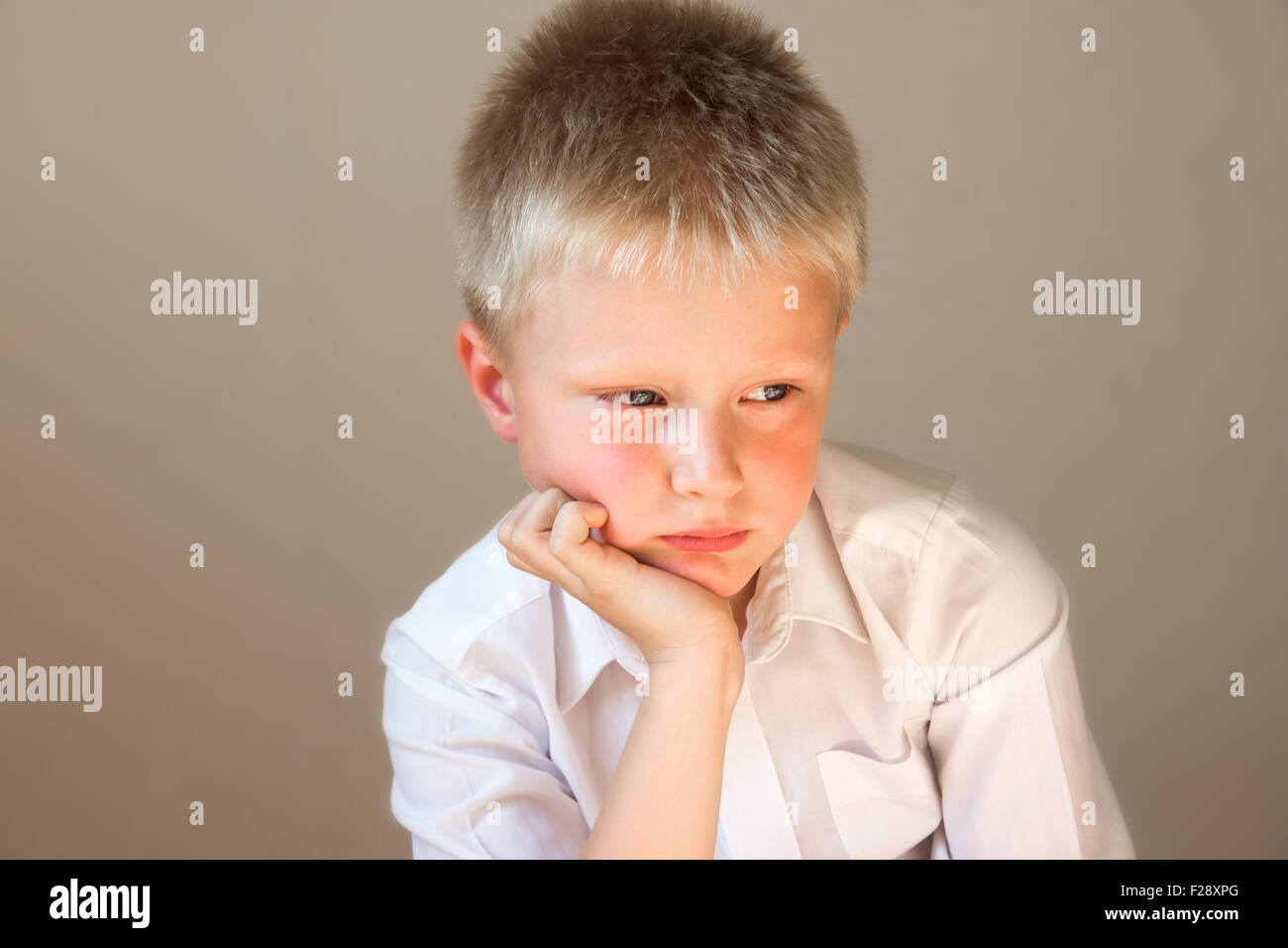 Sad upset tired worried unhappy school child (boy) close up horizontal  portrait with copy space Stock Photo