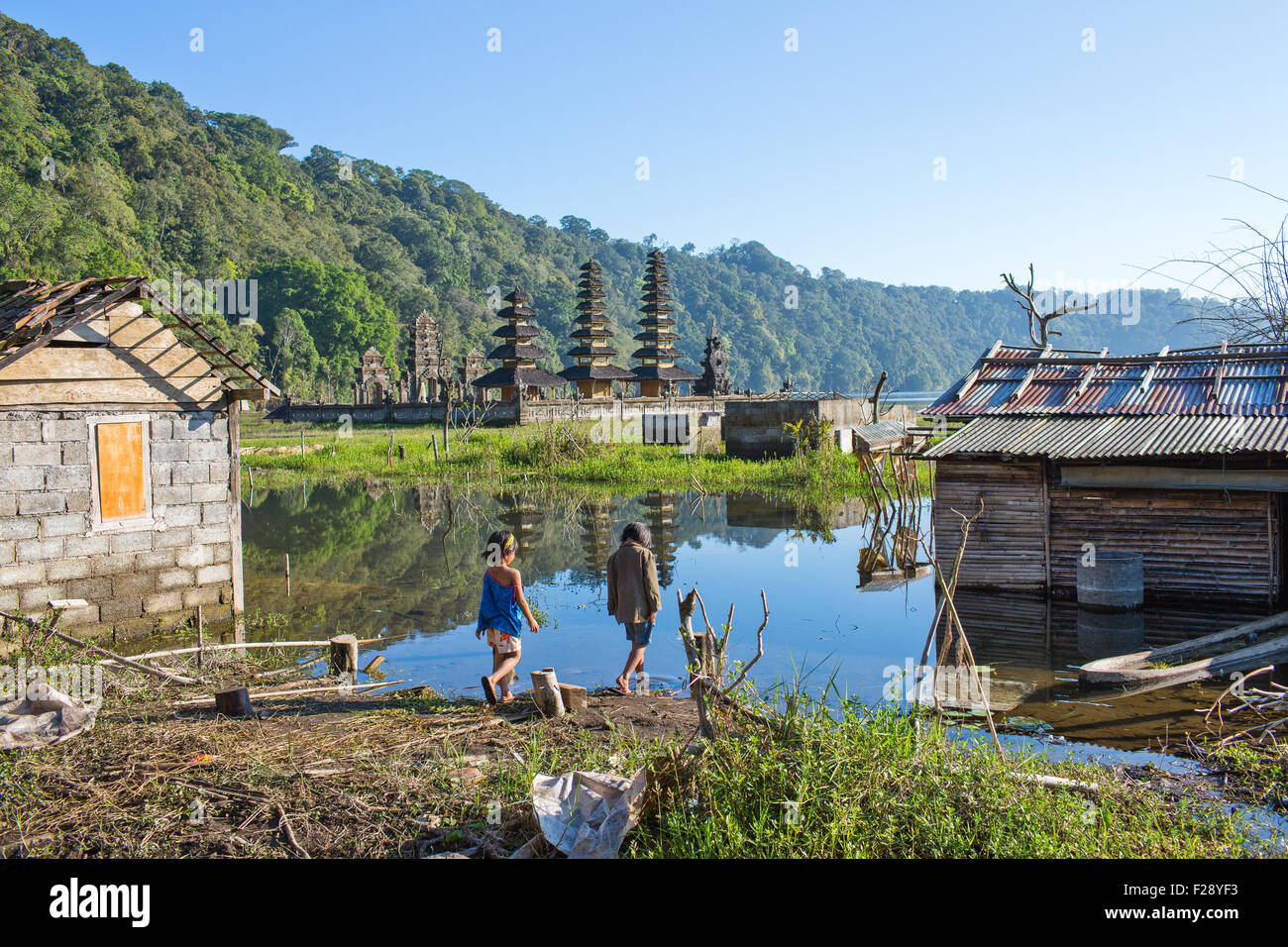 Two children by the water at their flooded village Stock Photo
