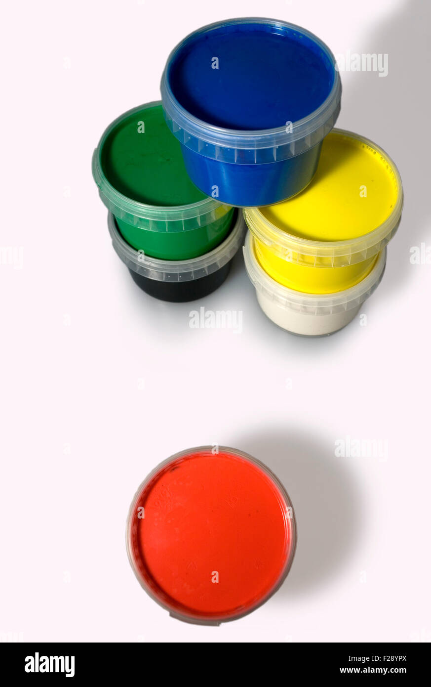 Jars of blue, yellow, red, white green and black colors isolated on a white background Stock Photo