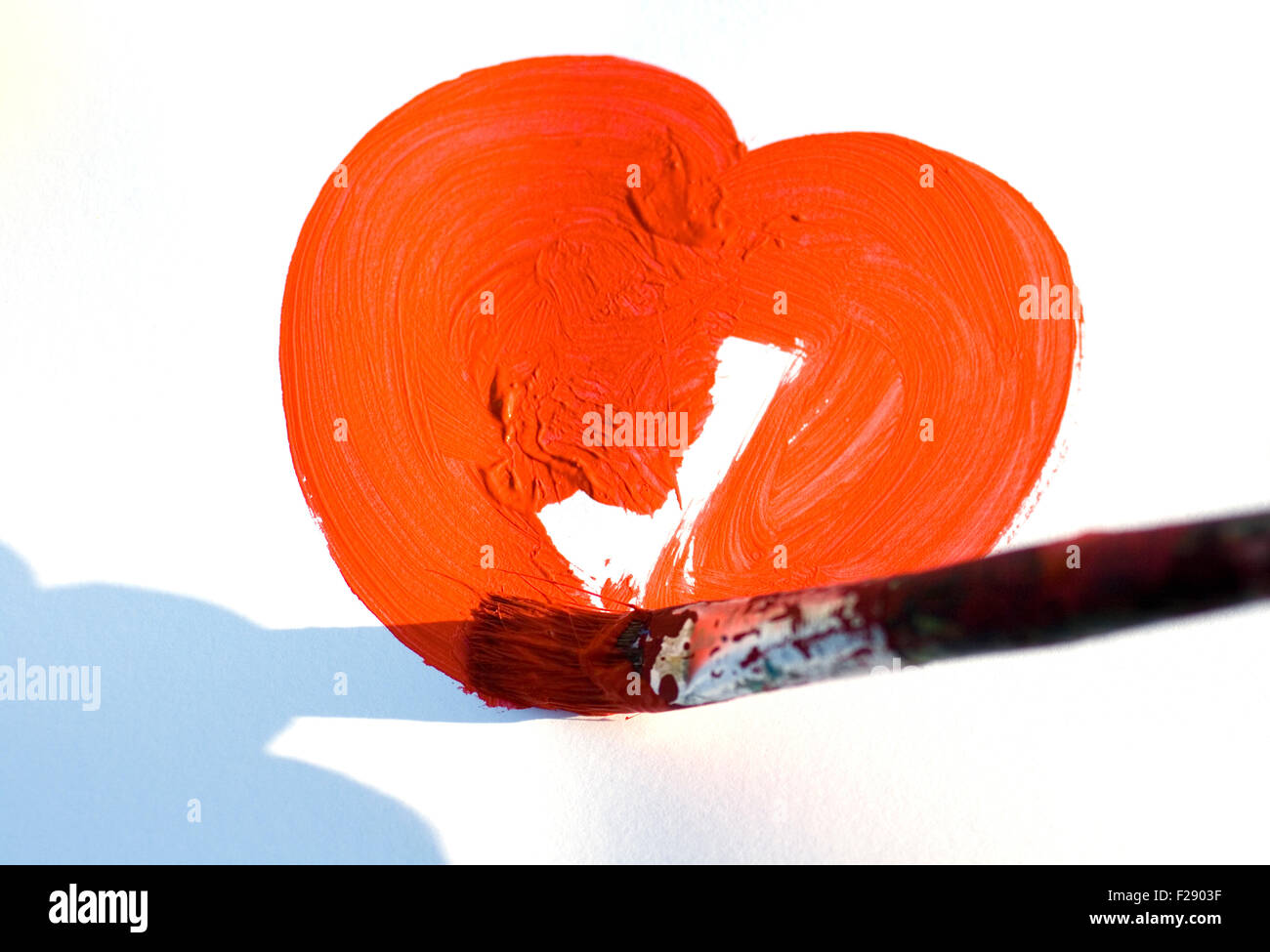 Painting a heart on white background Stock Photo