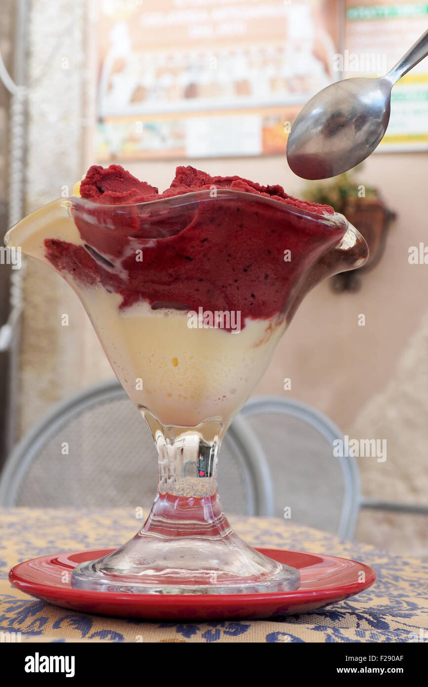 Strawberry and vanilla gelati in a glass bowl. Stock Photo