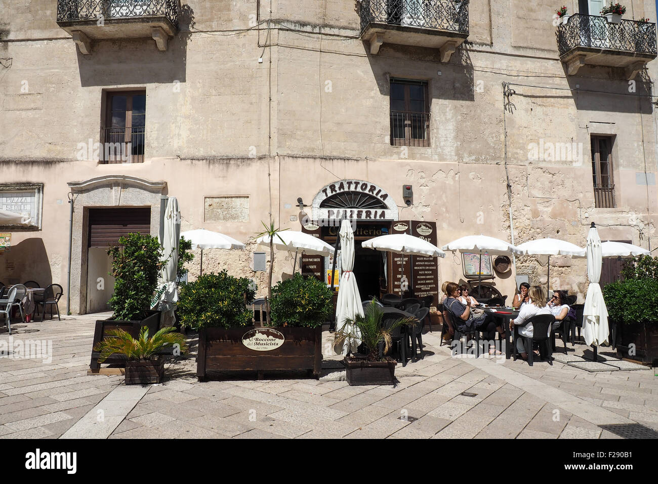 Women enjoying a coffee and cigarette alfresco in a piazza, Matera Basilicata Italy. Stock Photo