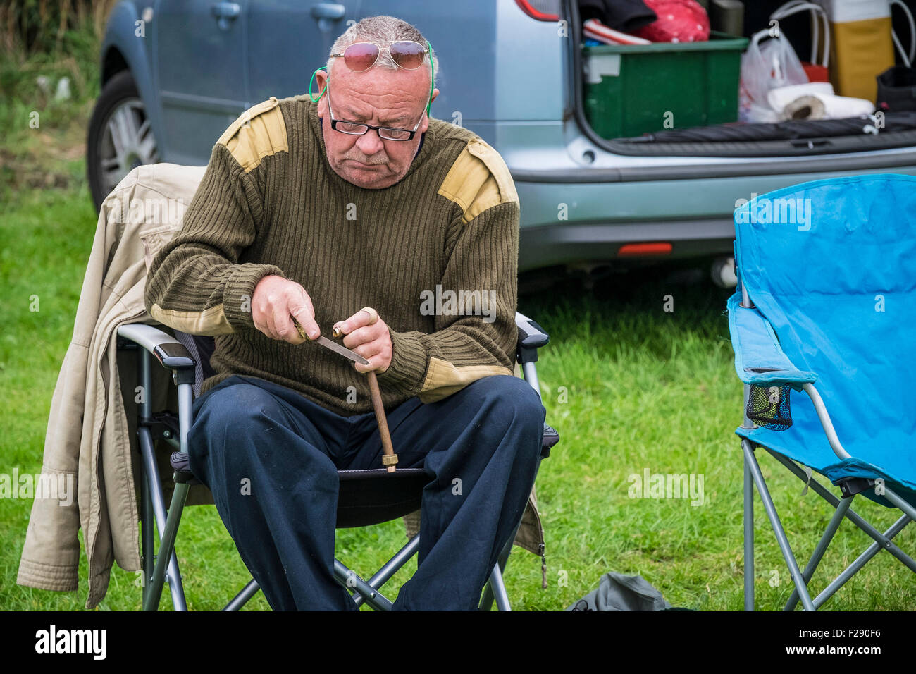 A man filing a piece of metal at the Essex Country Show, Barleylands, Essex. Stock Photo