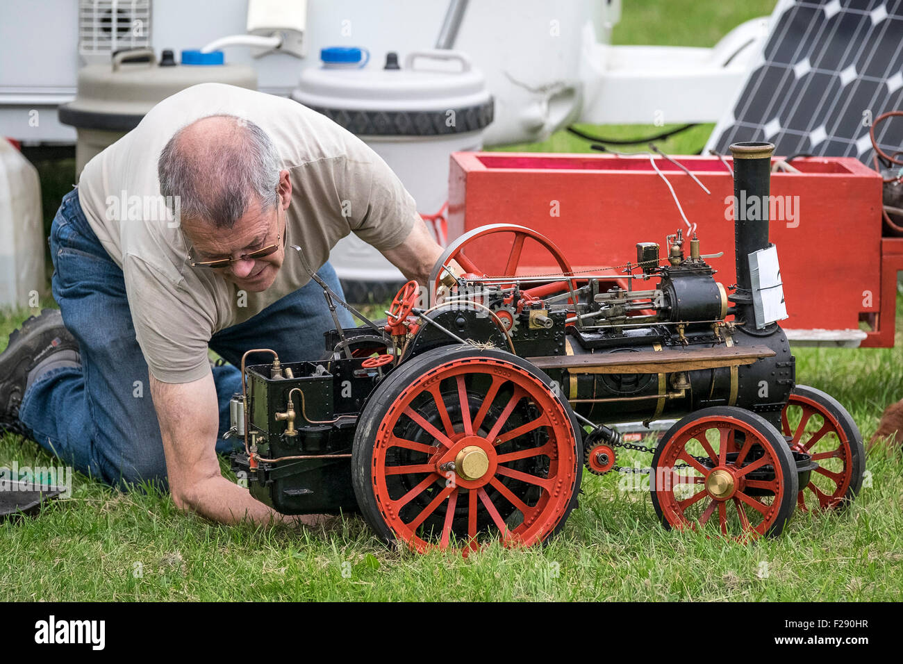The owner of a model steam engine carrying out maintenance at the Essex Country Show, Barleylands, Essex. Stock Photo