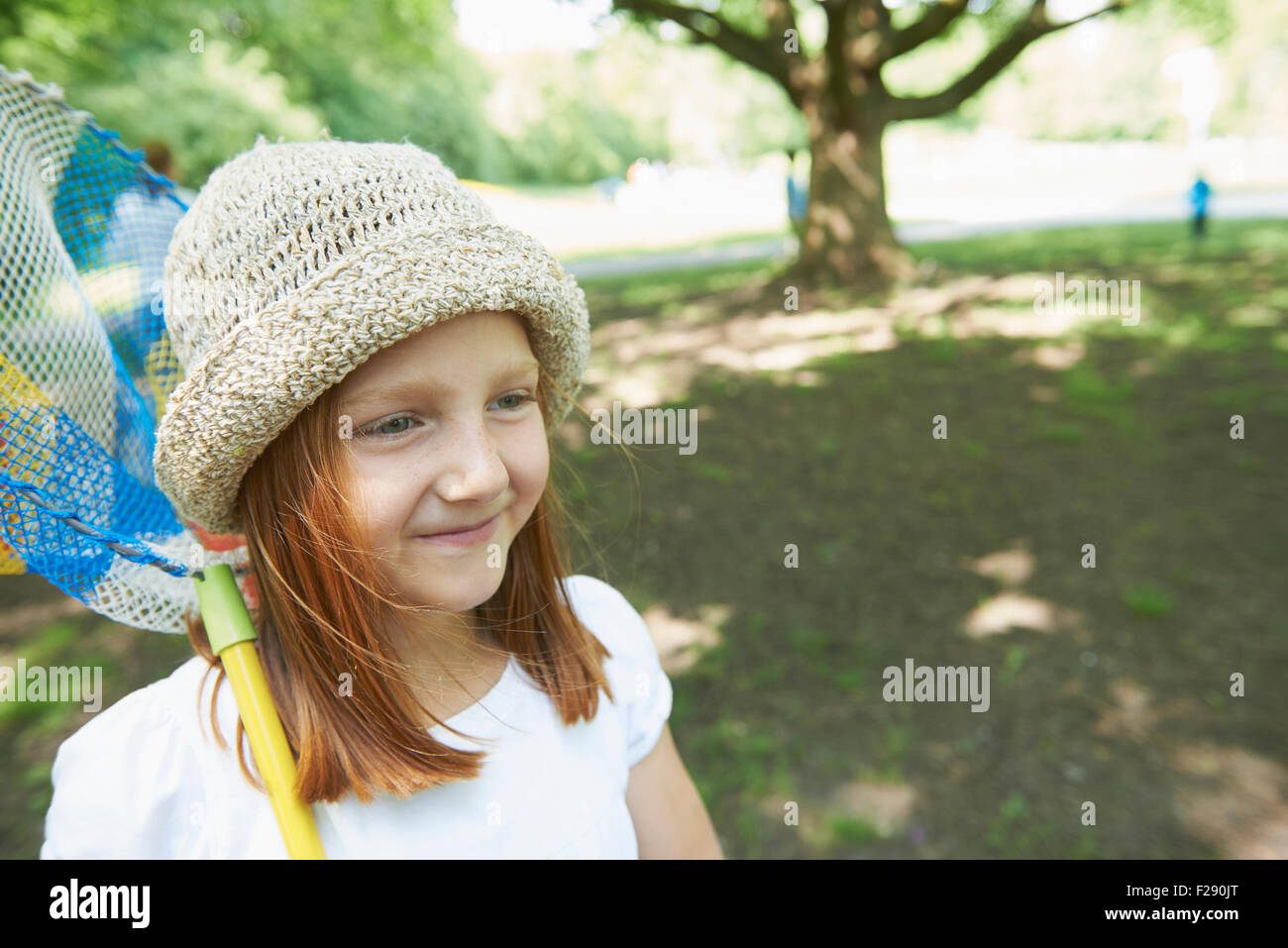 Caucasian little girl fishing. Full length of smiling girl holding