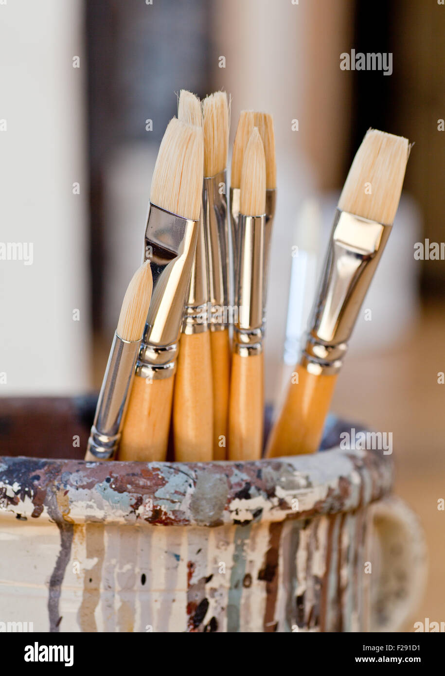 New paintbrushes in a old ceramic jar Stock Photo Alamy
