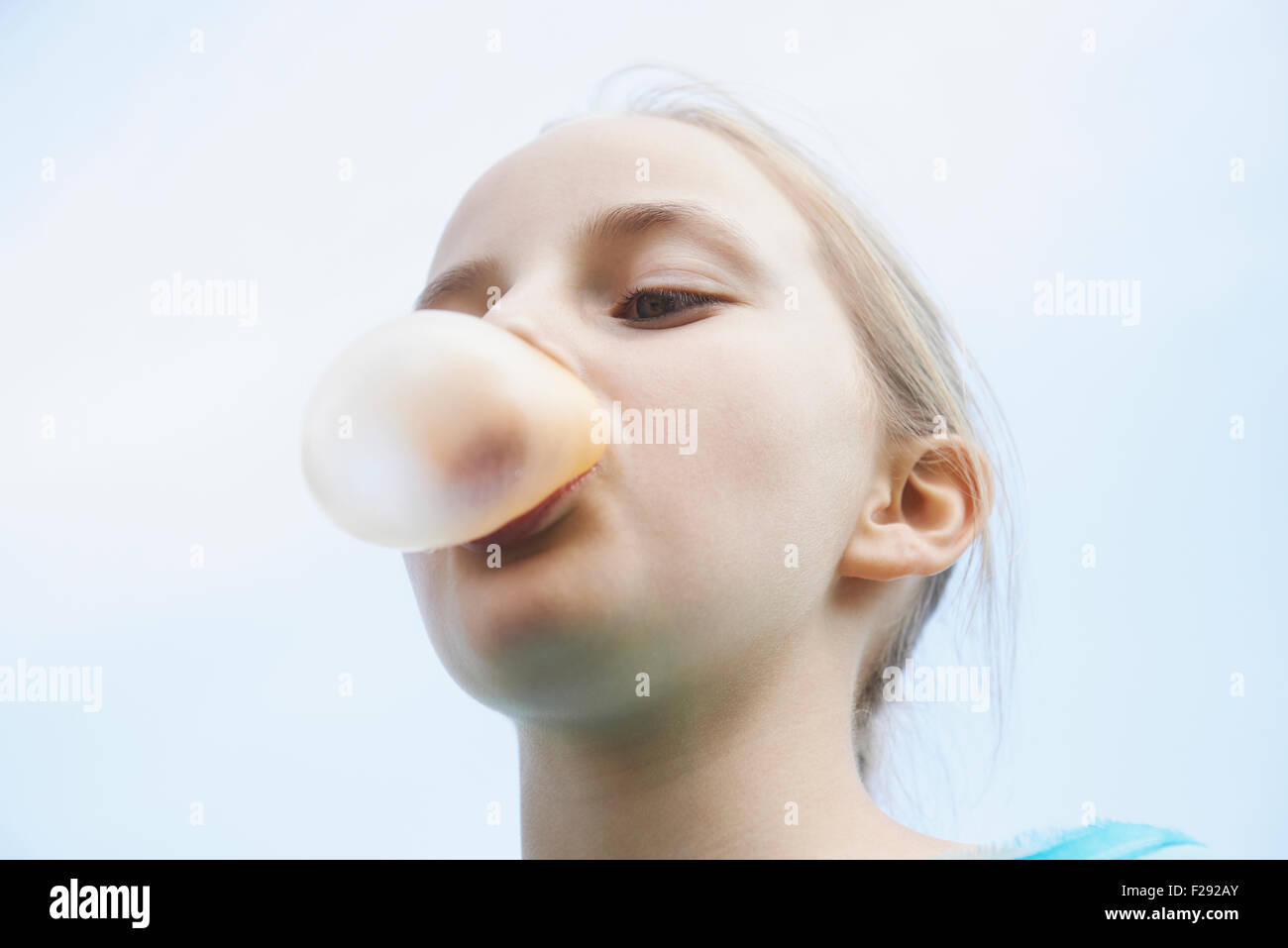 Girl blowing chewing gum bubble, Bavaria, Germany Stock Photo