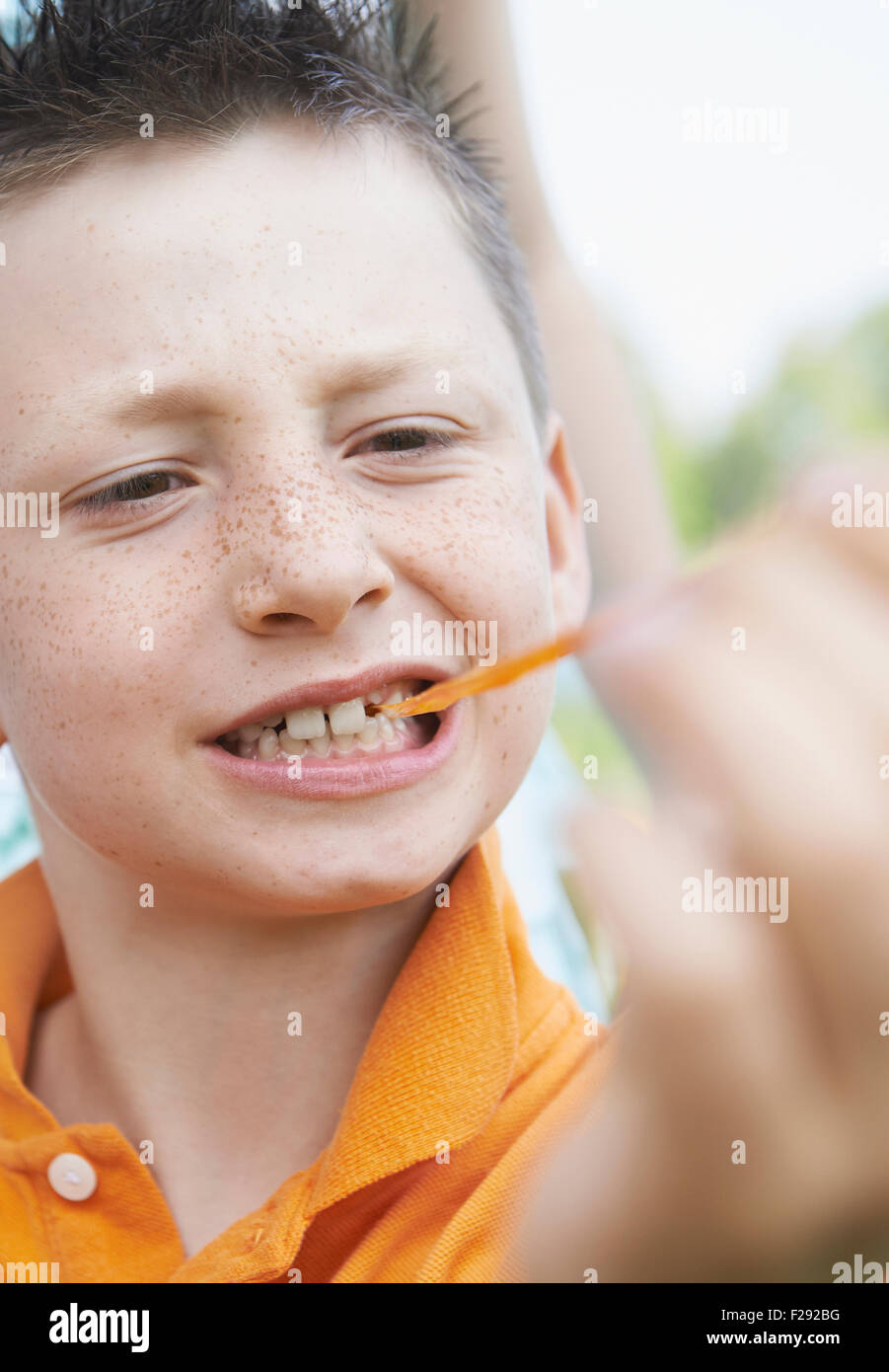 Boy pulling bubble gum out of his mouth, Bavaria, Germany Stock Photo