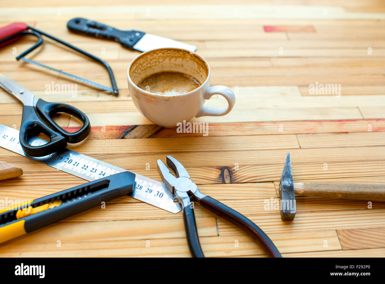 Different reapair instruments with cup of coffee on the woden table Stock Photo