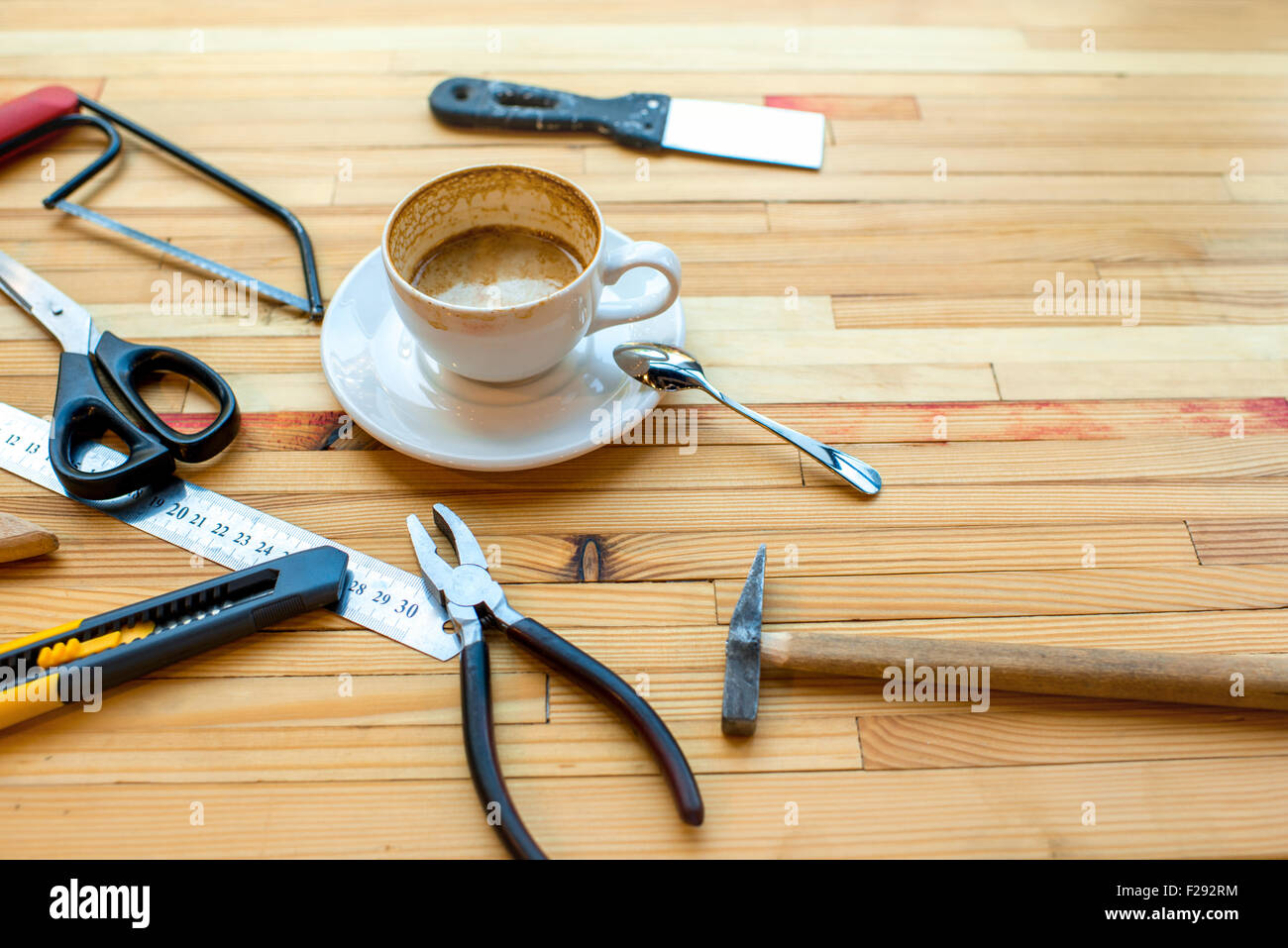 Different reapair instruments with cup of coffee on the woden table Stock Photo