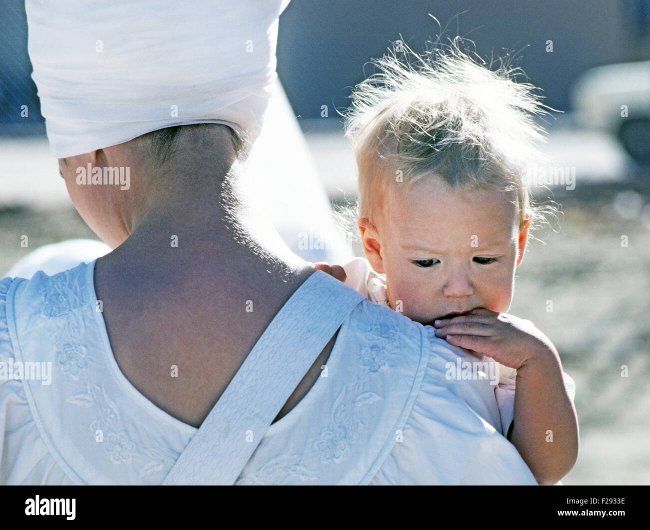 A young American sikh boy being held by his mother in the Sikh Ashram