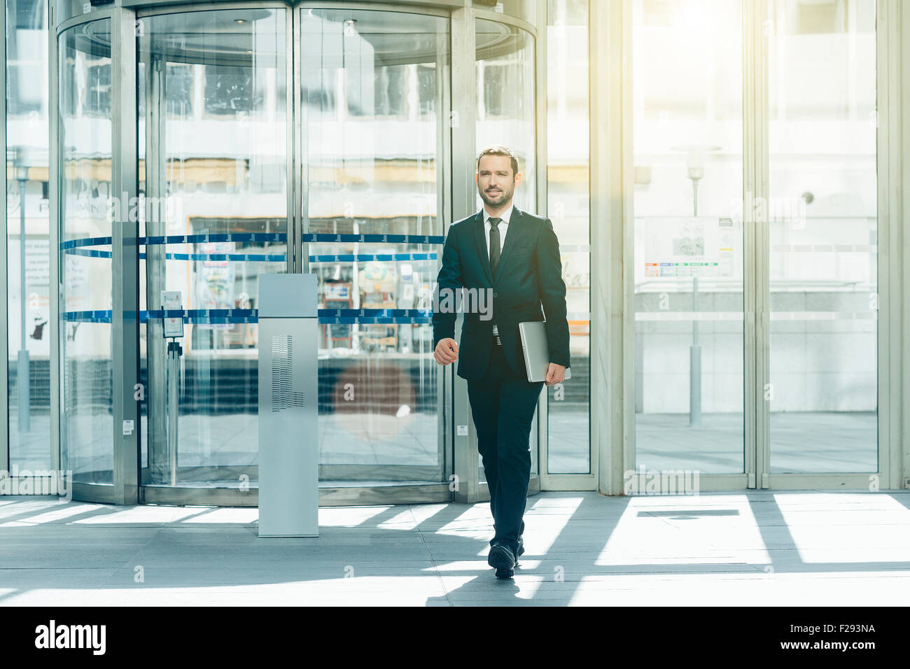 Businessman walking in entrance hall Stock Photo