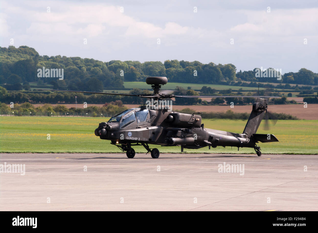 Side view Of A British Army AH MK1 Apache Longbow Helicopter Taxiing On Runway Stock Photo