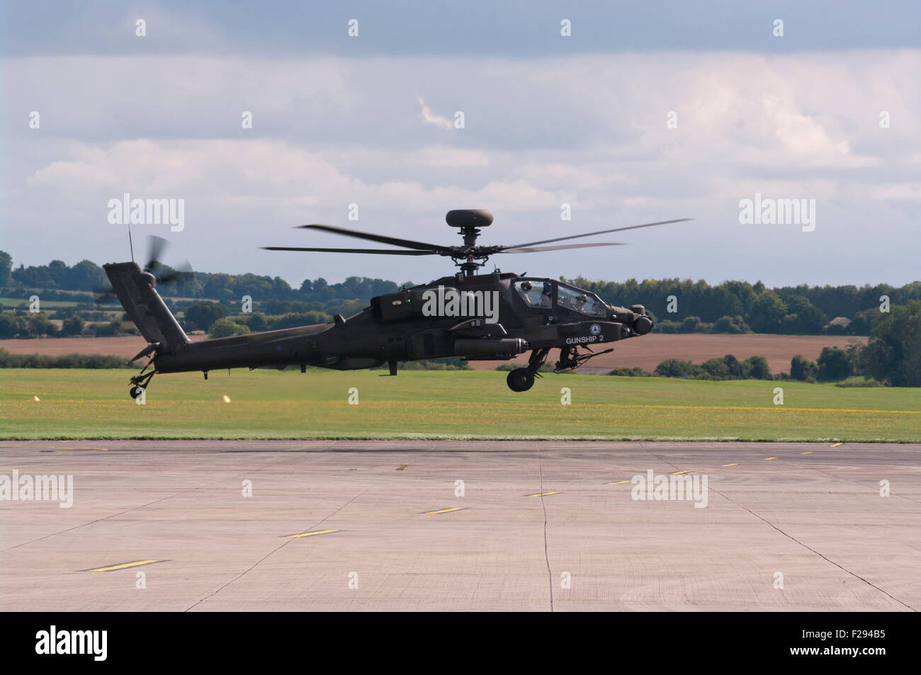 Side view Of A British Army AH MK1 Apache Longbow Helicopter Taking Off Stock Photo