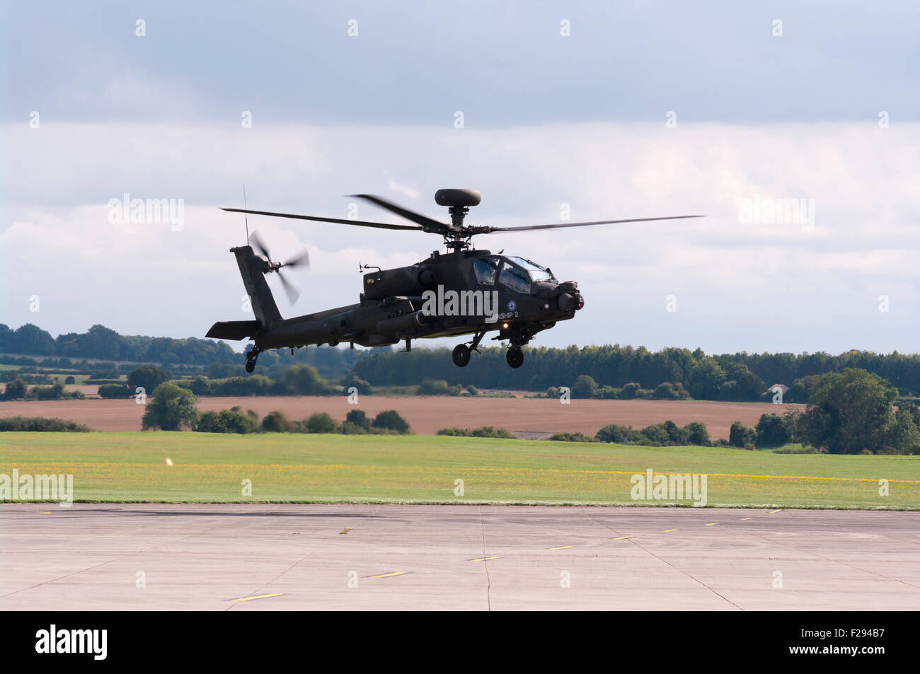 Side view Of A British Army AH MK1 Apache Longbow Helicopter landing Stock Photo