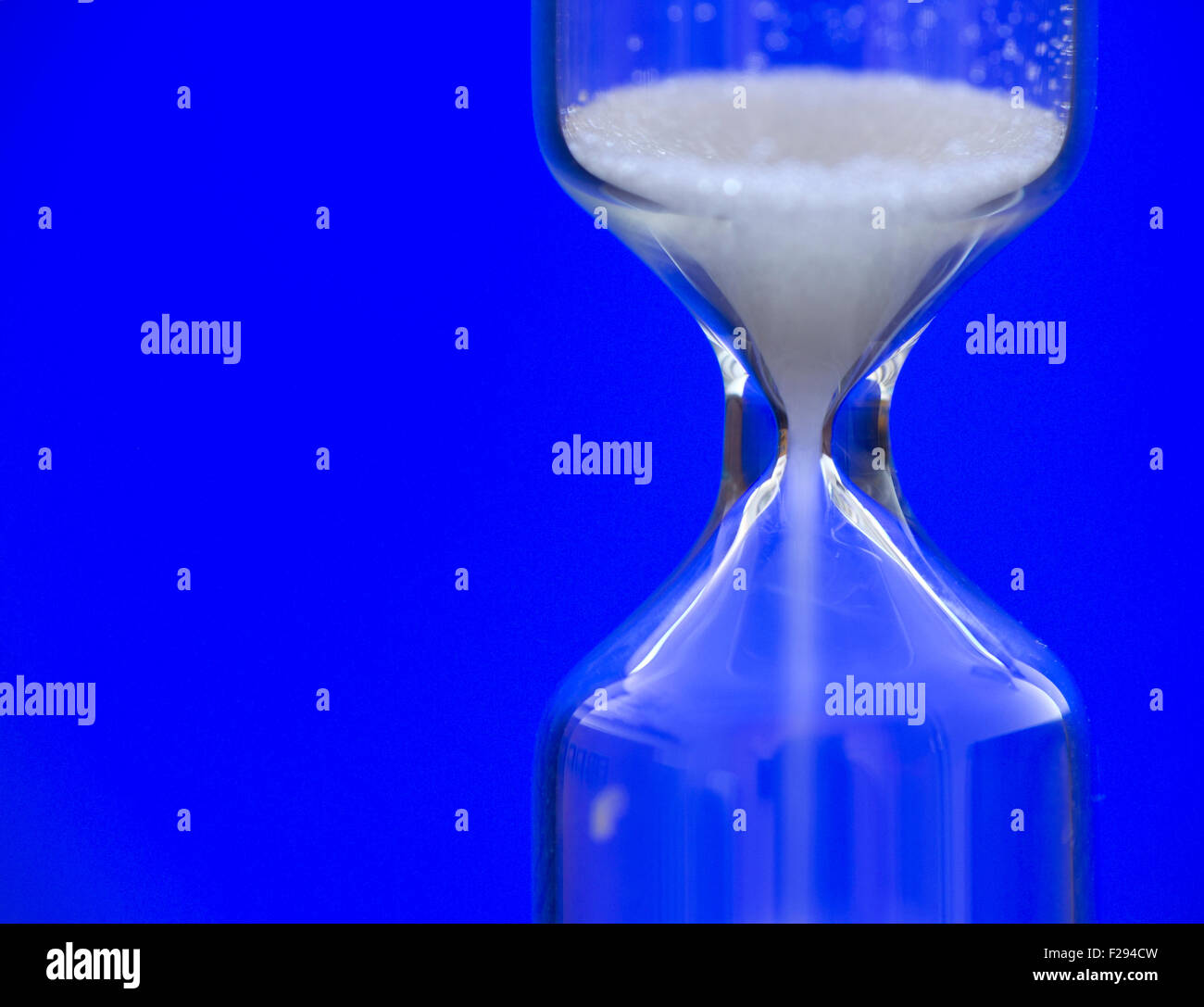 Hourglass against a blue background Stock Photo