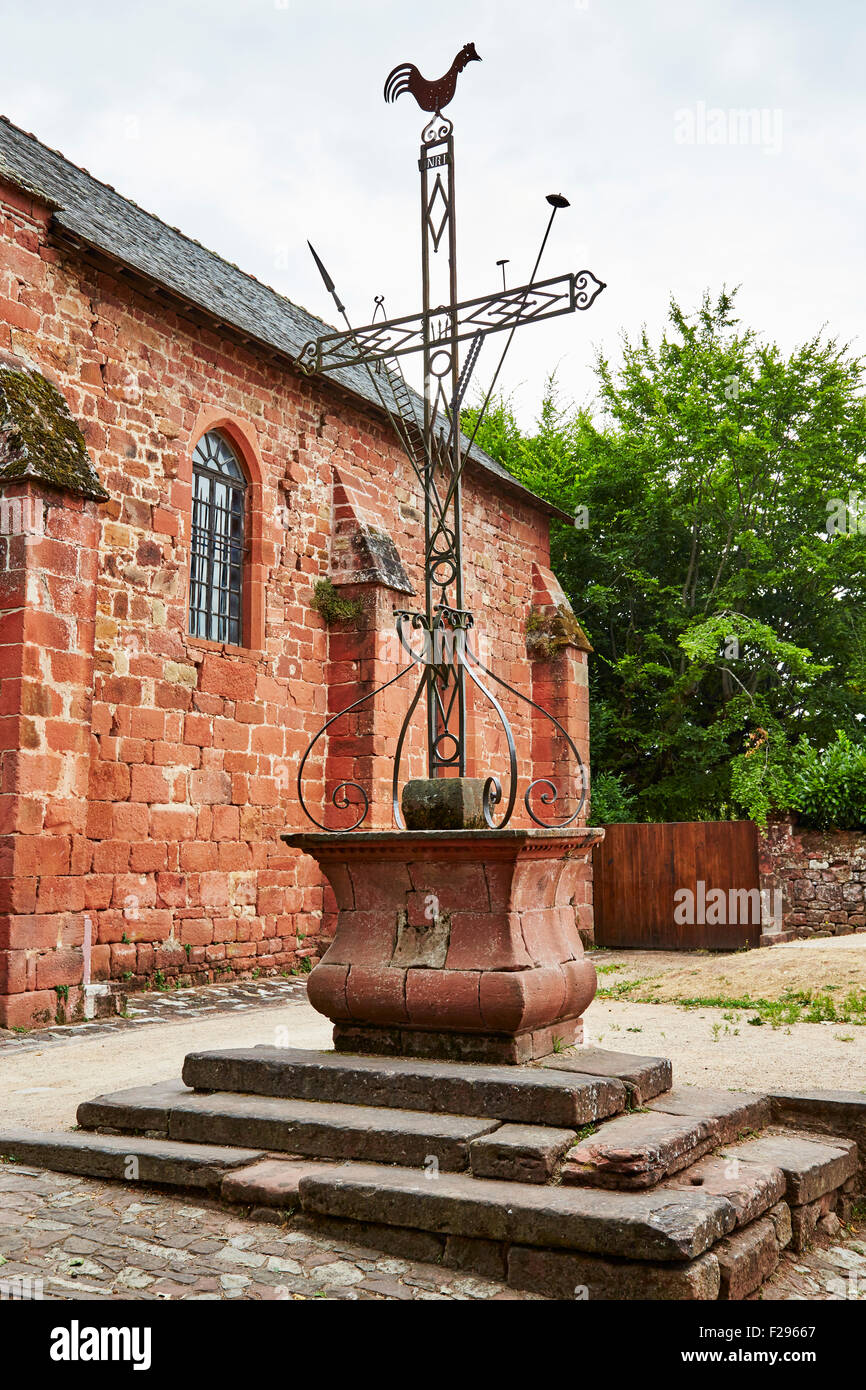 Ornate metal crucifix at the Church of Saint Peter in the village of Collonges-la-Rouge, Correze, Limousin, France. Stock Photo