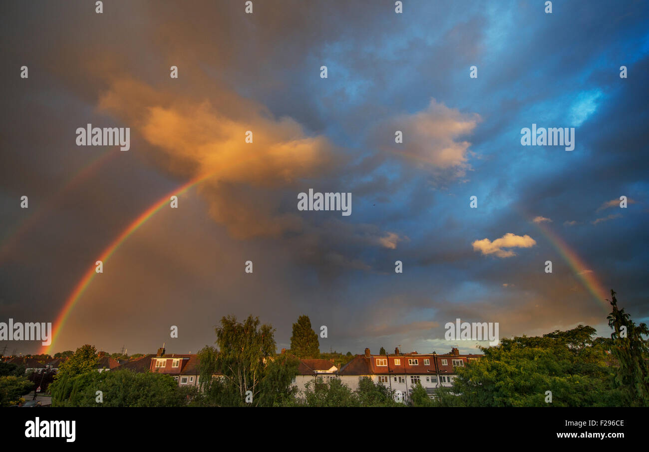 Wimbledon, S.W. London, UK. 14th September 2015. A rainbow forms in evening sunlight over rooftops in south London after a day of sunshine and heavy showers. Credit:  Malcolm Park editorial/Alamy Live News Stock Photo