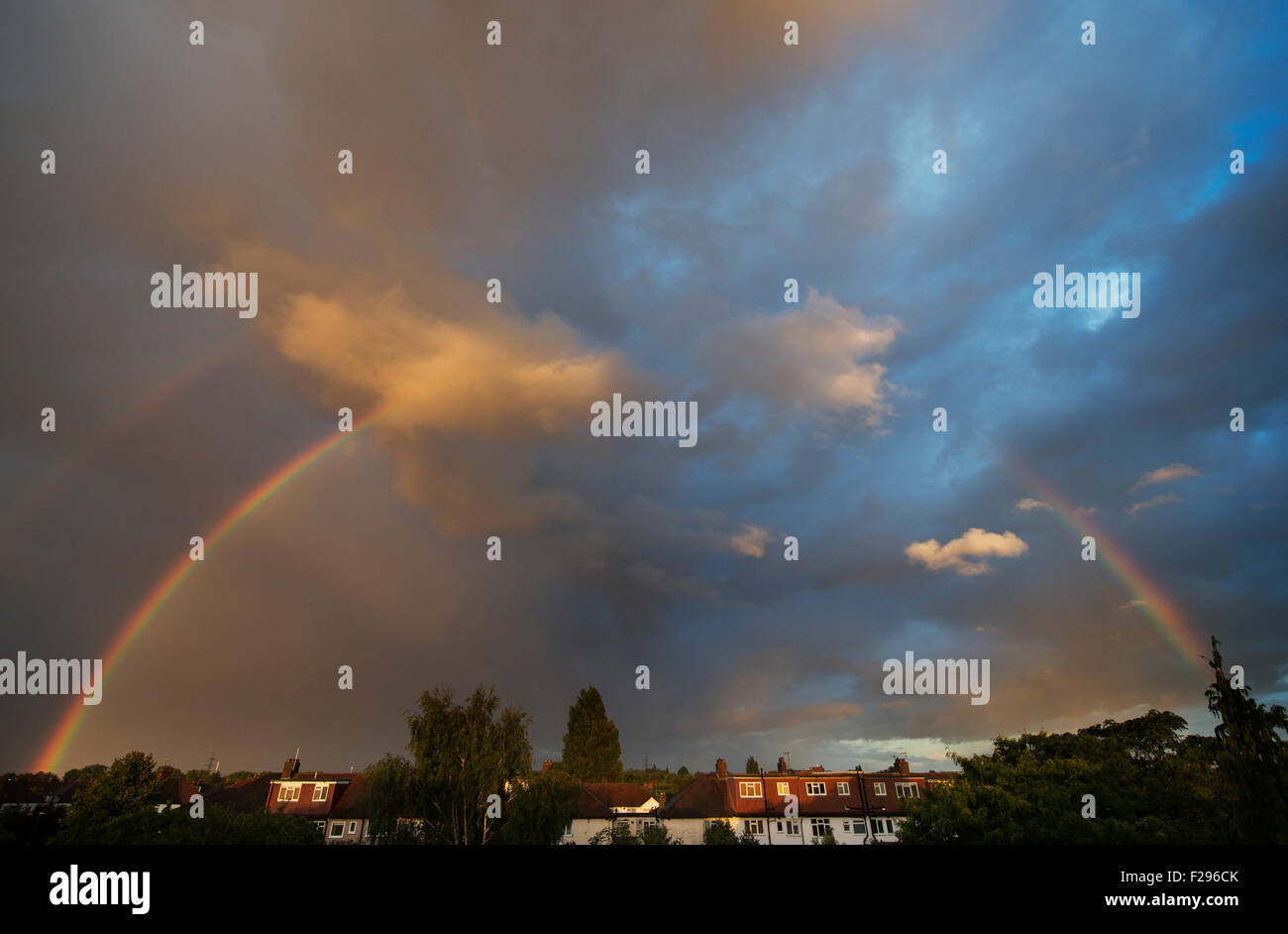 Wimbledon, S.W. London, UK. 14th September 2015. A rainbow forms in evening sunlight over rooftops in south London after a day of sunshine and heavy showers. Credit:  Malcolm Park editorial/Alamy Live News Stock Photo