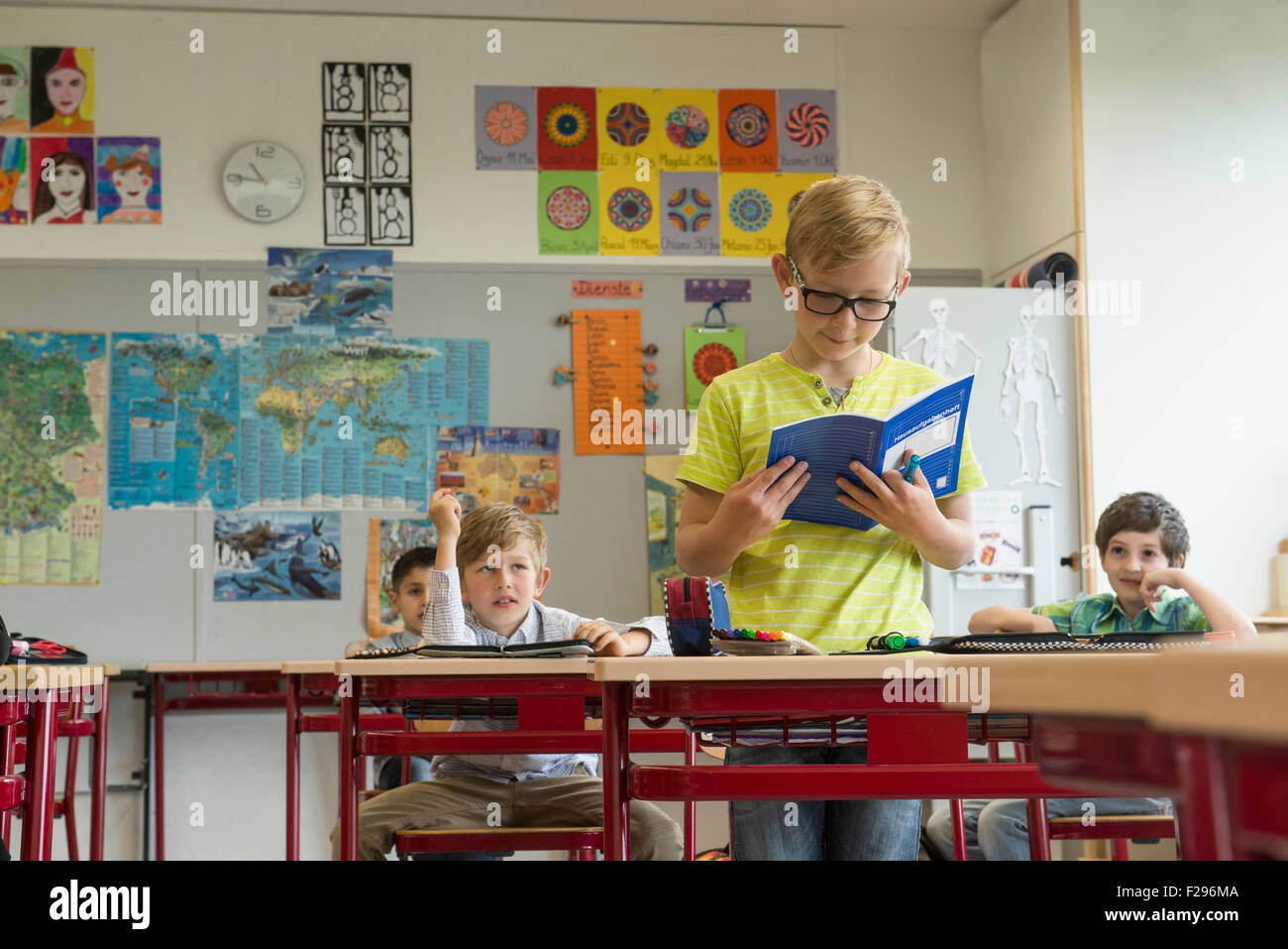 schoolboy reading a book in classroom, Munich, Bavaria, Germany Stock Photo