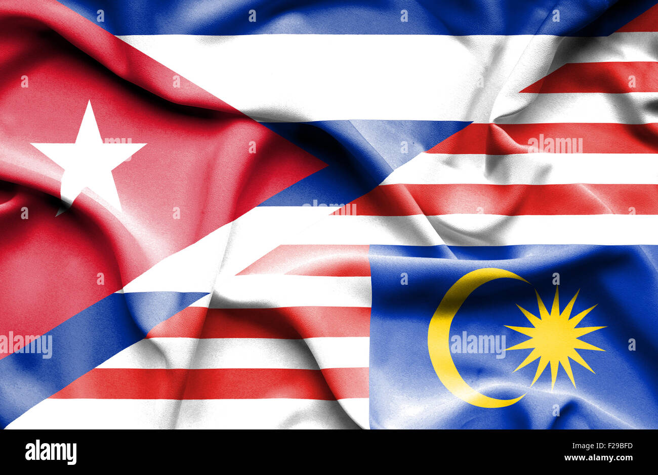 Waving flag of Malaysia and Cuba Stock Photo