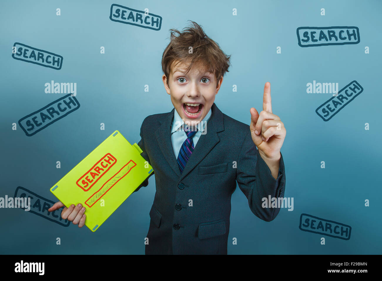 a boy of twelve European appearance in a suit holding a blank sh Stock Photo