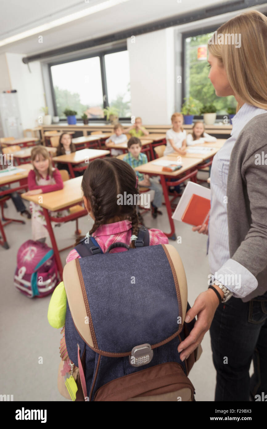 Female teacher introducing a new classmate in classroom, Munich, Bavaria, Germany Stock Photo