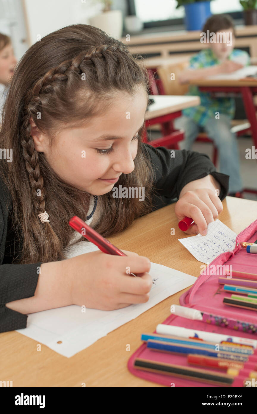 schoolgirl cheating in examination, Munich, Bavaria, Germany Stock Photo