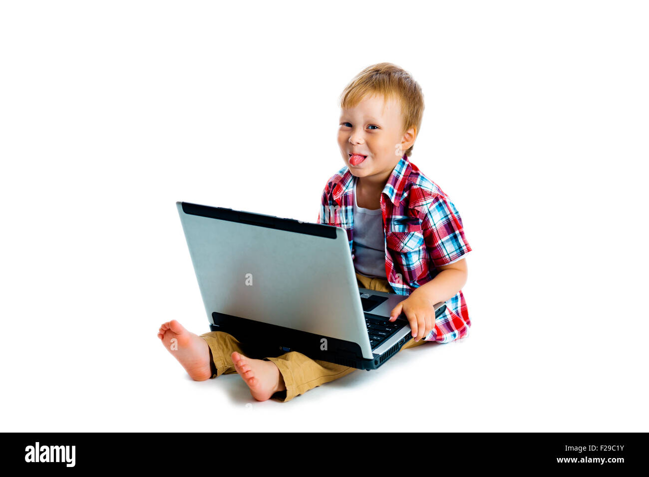 The little boy with a laptop sitting on the floor Stock Photo - Alamy