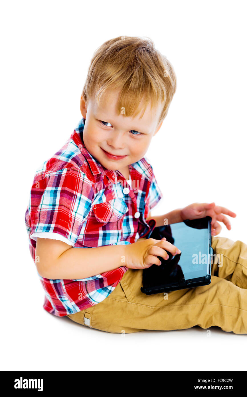 Little boy with a Tablet PC sitting on the floor Stock Photo - Alamy