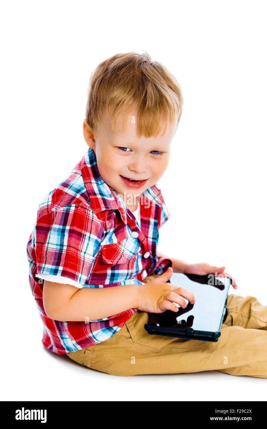 Little boy with a Tablet PC sitting on the floor Stock Photo - Alamy