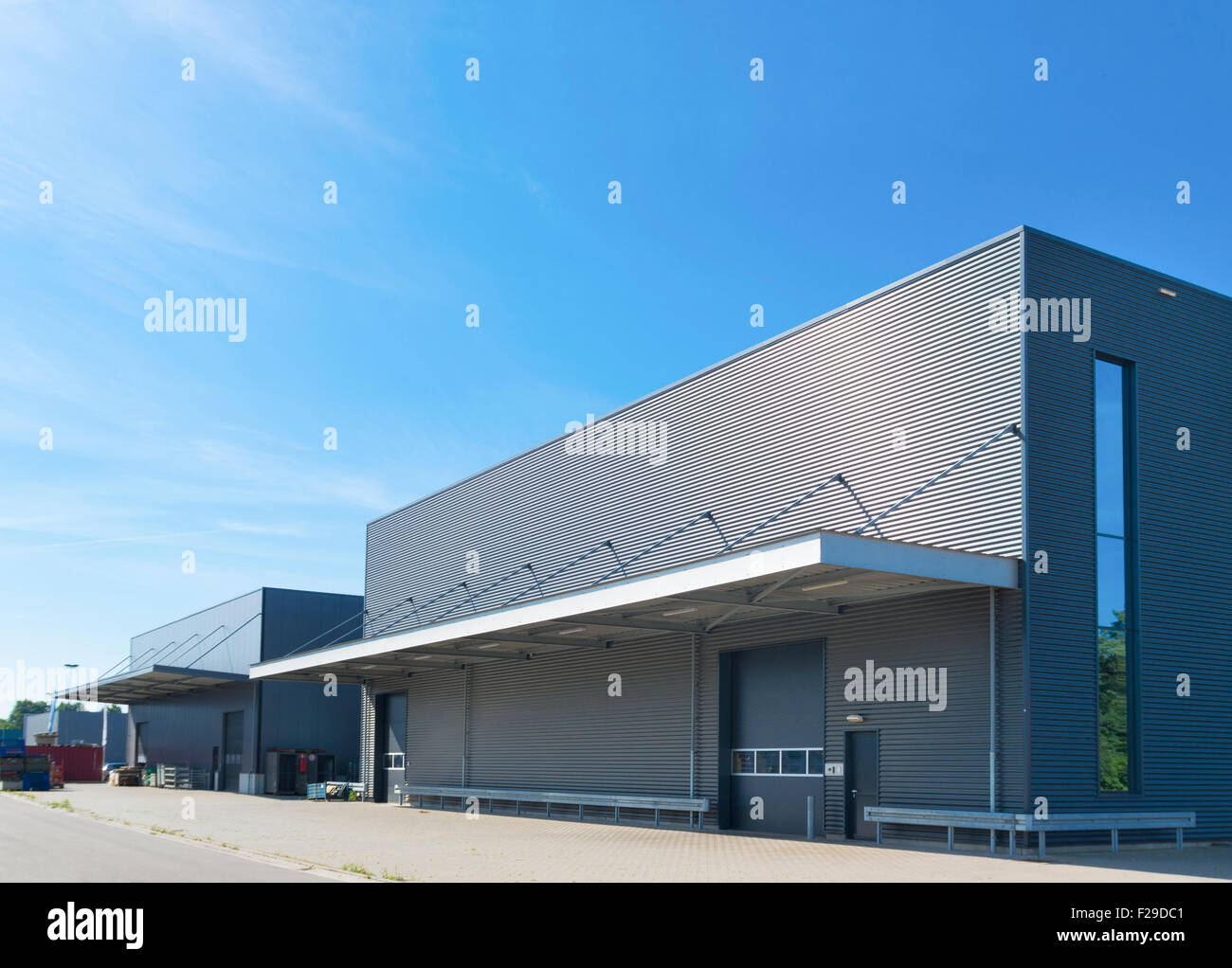 exterior of a modern warehouse building against a blue sky Stock Photo