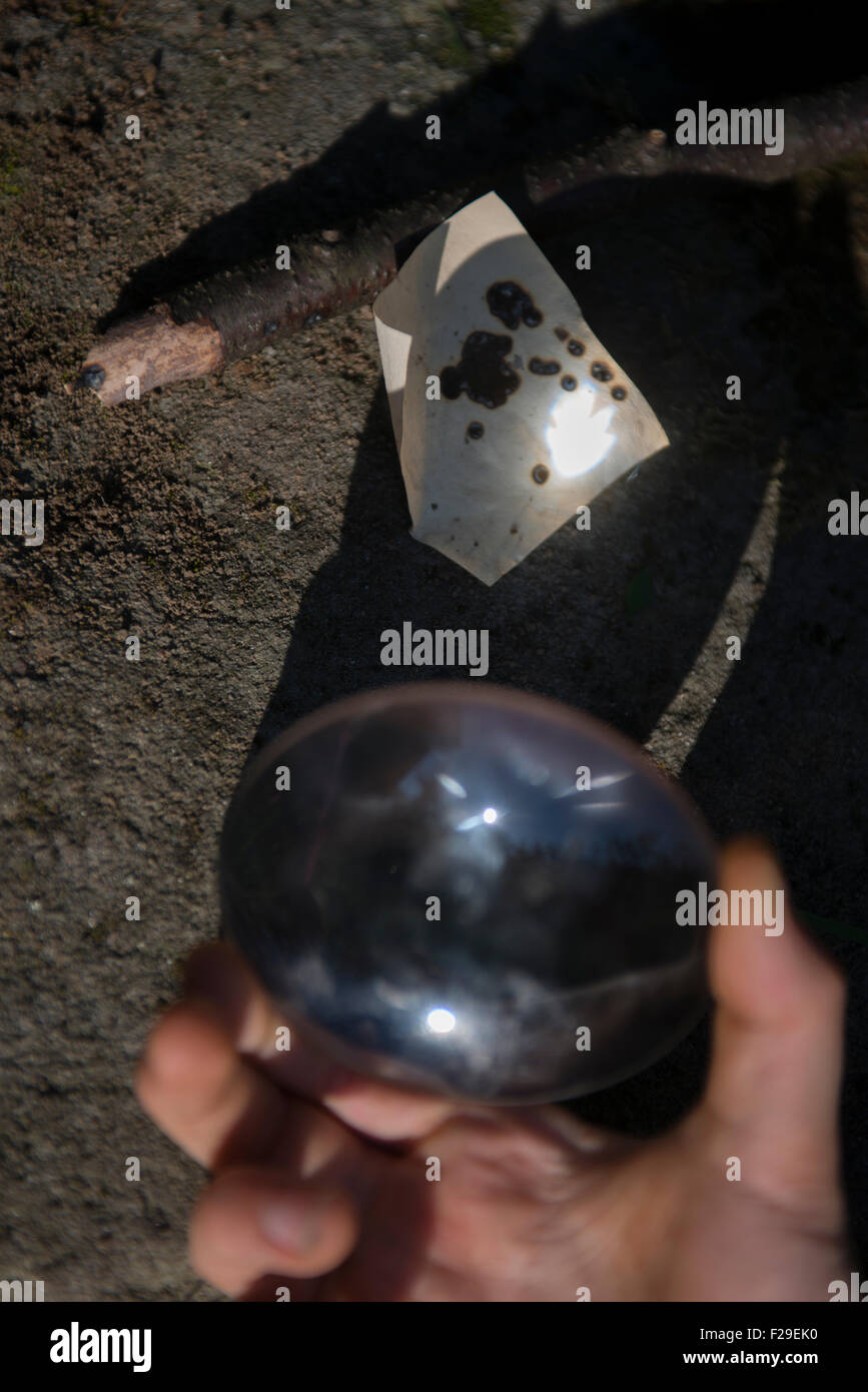 Boy Starting a Fire with a Magnifying Glass Stock Photo Alamy