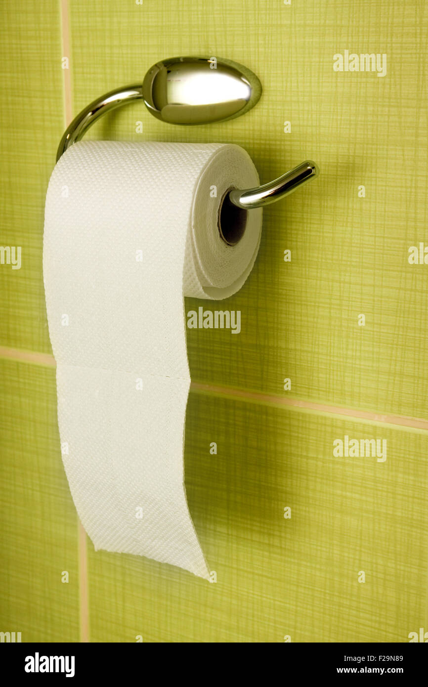 Rolled toilet paper hanging in the bathroom Stock Photo