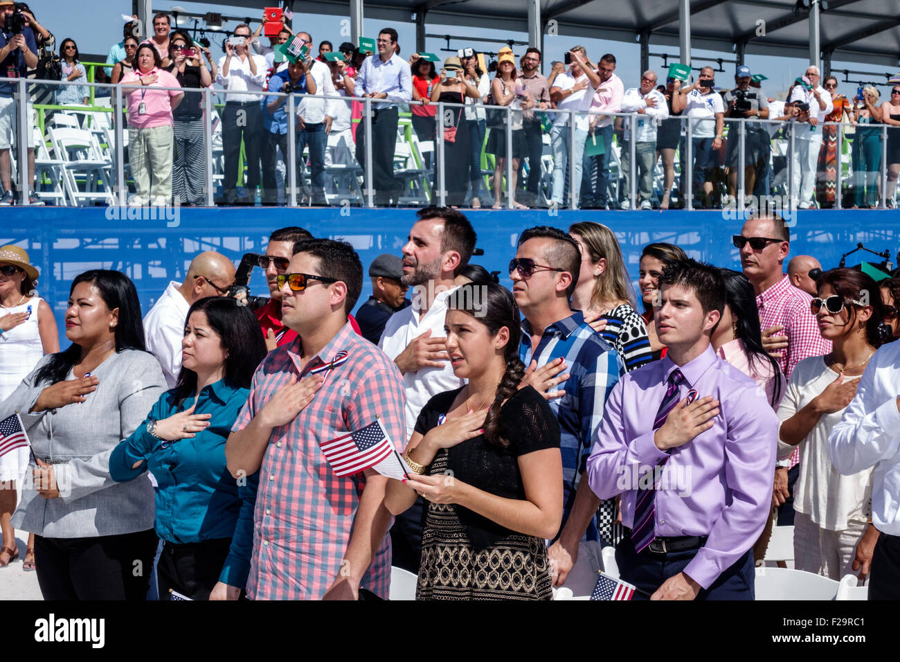 Miami Beach Florida,Oath of Citizenship Ceremony,immigrants,naturalization,citizen,swearing in,new citizens,Pledge of Allegiance,hand over heart,recit Stock Photo