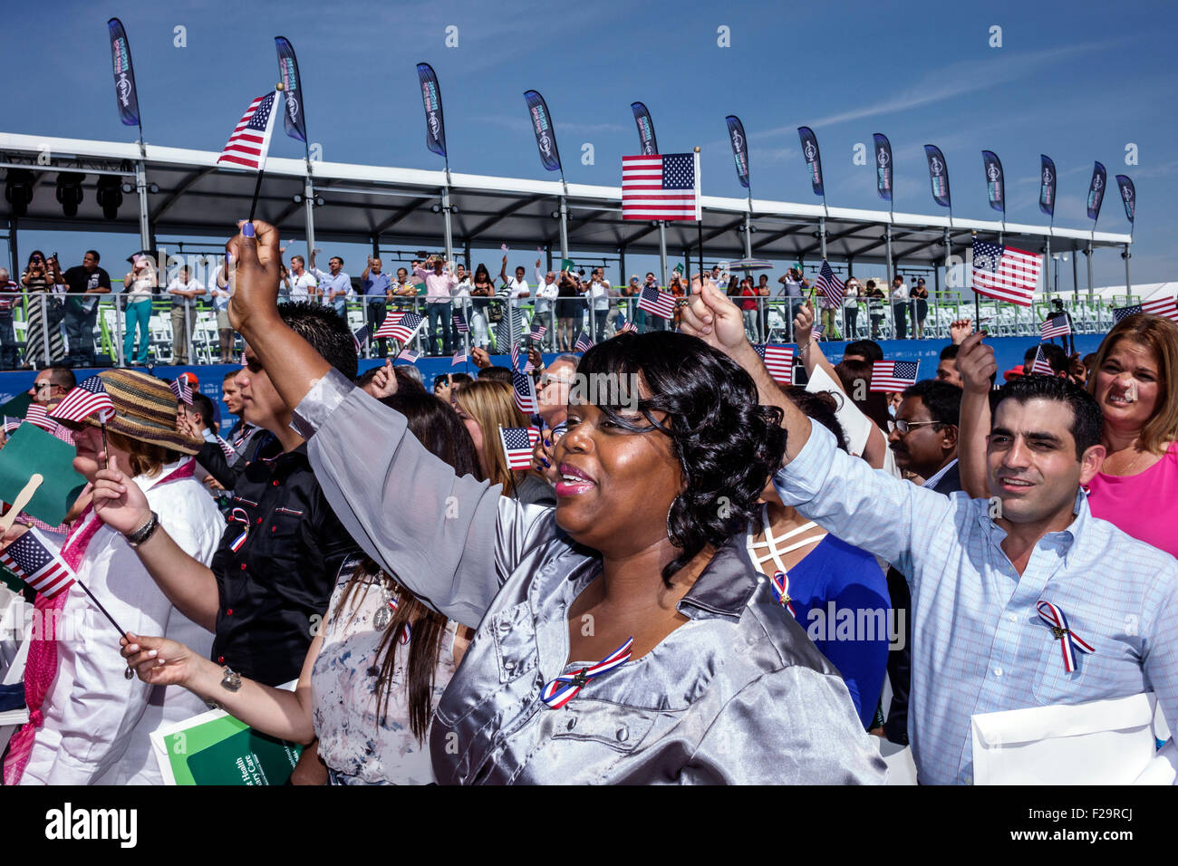 Miami Beach Florida,Oath of Citizenship Ceremony,immigrants,naturalization,citizen,swearing in,new citizens,allegiance,waving flags,Black Afro America Stock Photo