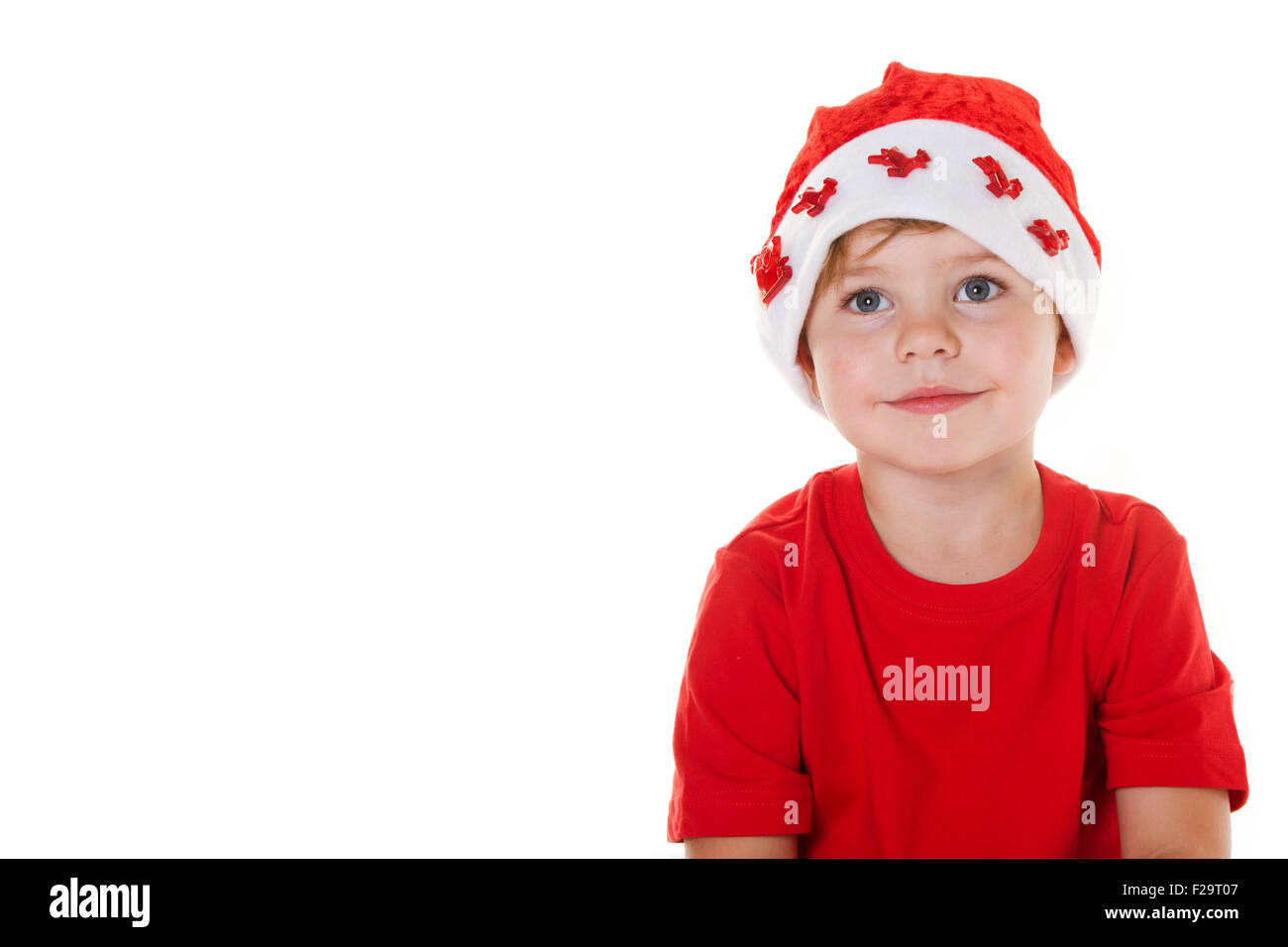 Young boy wearing a Santa hat looking away from the camera. Stock Photo