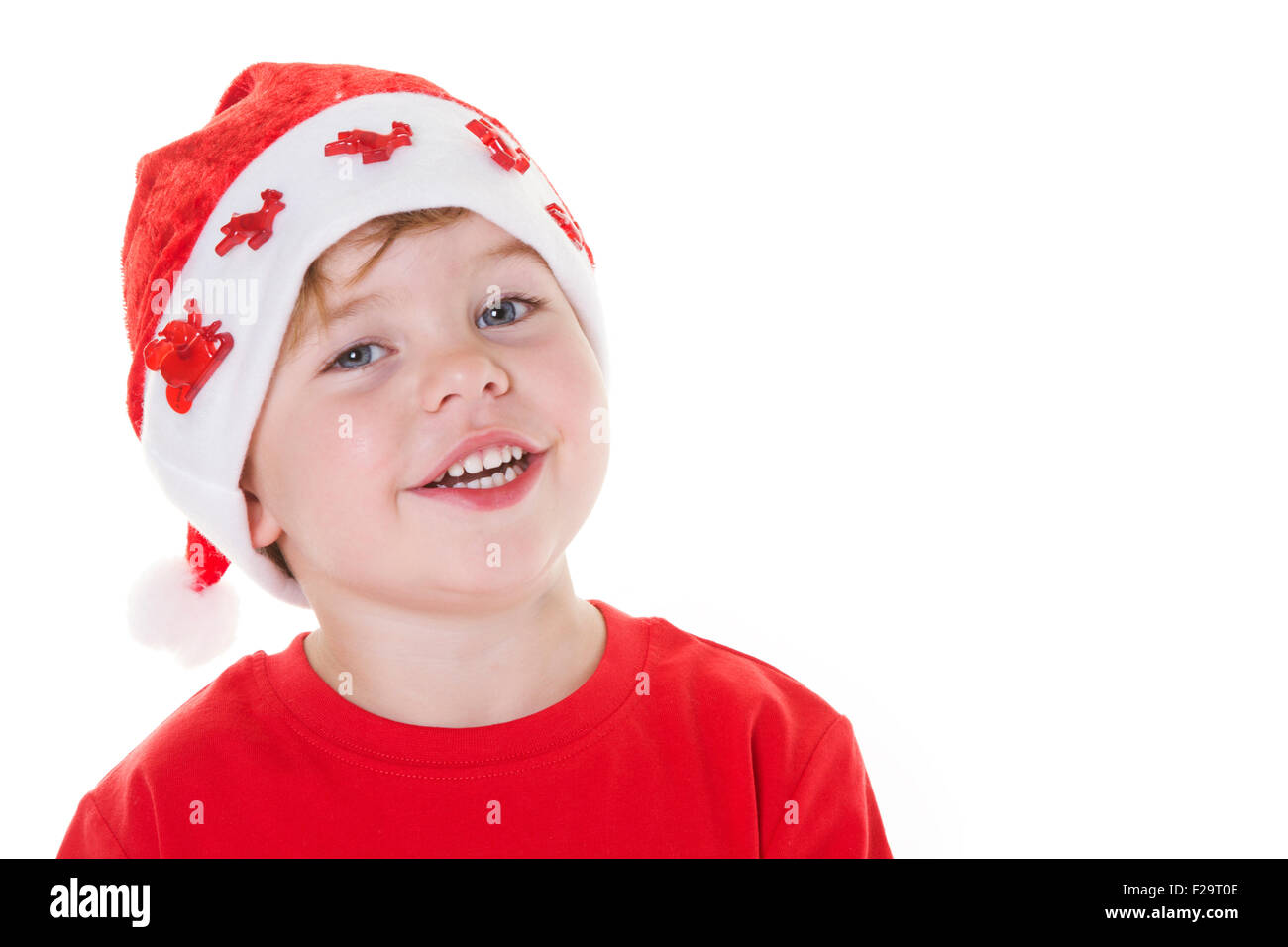 Young boy wearing a Santa hat smiling at the camera. Stock Photo