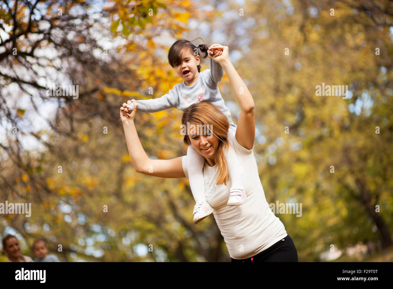 Mother an daughter in the autumn park Stock Photo - Alamy