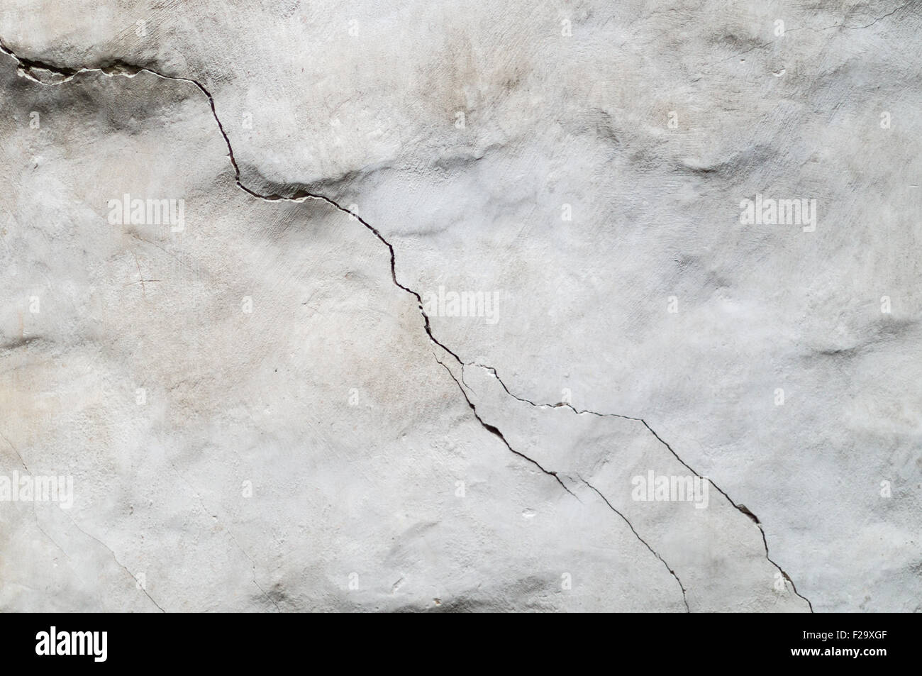 Old concrete wall with diagonal crack Stock Photo